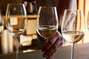 A sommelier prepares a glass of Riesling wine for tasting