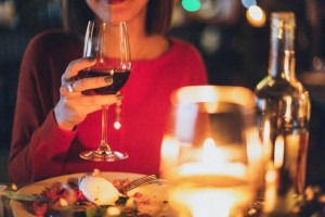 A women drinking a glass of red wine