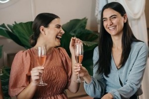An image of two women enjoying a glass of rosé wine