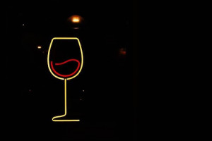 An image of a neon sign depicting a glass of red wine