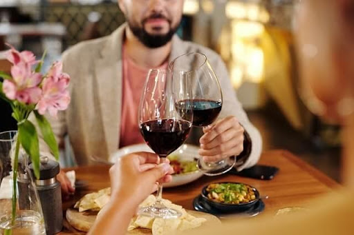 An image of two people enjoying a recommended Cabernet Sauvignon food pairing