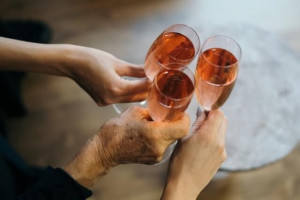 An image of three people holding glasses of French rosé wine
